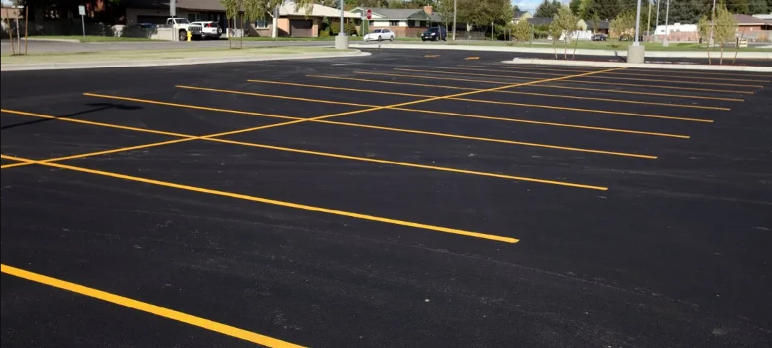 Freshly striped commercial parking lot with crisp yellow lines, Tulsa OK